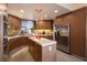 Spacious kitchen showcasing island, stainless appliances, custom wood cabinets, and granite countertops at 7315 Mission Hills Dr, Las Vegas, NV 89113