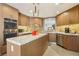 Bright kitchen featuring stainless appliances, granite countertops, custom wood cabinets, and a kitchen island at 7315 Mission Hills Dr, Las Vegas, NV 89113