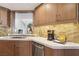 Stylish kitchen counter with stainless steel appliances, tile backsplash, and view to living area at 7315 Mission Hills Dr, Las Vegas, NV 89113