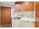 Laundry room with modern washer and dryer, storage cabinets, and convenient layout at 7315 Mission Hills Dr, Las Vegas, NV 89113