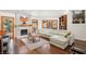Bright living room with a sleek fireplace, hardwood floors, and a large sectional sofa at 7315 Mission Hills Dr, Las Vegas, NV 89113
