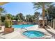 Resort-style community pool area with a jacuzzi surrounded by lounge chairs and large palm trees at 7315 Mission Hills Dr, Las Vegas, NV 89113
