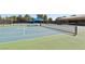 Community tennis court with well maintained surface and surrounding fencing in a park-like setting at 7315 Mission Hills Dr, Las Vegas, NV 89113
