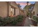 Charming walkway surrounded by lush greenery leading to the front entrance of the home at 7315 Mission Hills Dr, Las Vegas, NV 89113