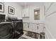 Functional laundry room with sleek, dark appliances, white cabinets, and counter space at 754 Spirit Lake St, Las Vegas, NV 89138