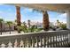 Balcony view of palm trees and neighborhood houses with tiled roofs at 7682 Calm Passage Ct, Las Vegas, NV 89139