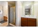 Bathroom with a sink and a gold-framed shower with patterned glass at 7682 Calm Passage Ct, Las Vegas, NV 89139