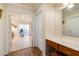 Bedroom leading to a bathroom featuring stationary bike and marble topped vanity at 7682 Calm Passage Ct, Las Vegas, NV 89139