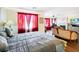 Bedroom with large bed, fireplace, red curtains, and sitting area at 7682 Calm Passage Ct, Las Vegas, NV 89139