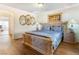 Bedroom with a large ornate bed, hardwood floors and ornate mirrors at 7682 Calm Passage Ct, Las Vegas, NV 89139