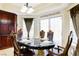 Dining room with marble table, chairs, decorative window, and built in cabinets at 7682 Calm Passage Ct, Las Vegas, NV 89139