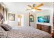 Cozy bedroom with dark wood furniture, four-poster bed, and a TV on the wall at 7682 Calm Passage Ct, Las Vegas, NV 89139