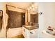 Bathroom with decorative tile walls, a bathtub, and a granite countertop sink at 7950 W Flamingo Rd # 1081, Las Vegas, NV 89147