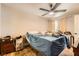 Bedroom featuring a ceiling fan, wood-look tile flooring and a window with curtains at 7950 W Flamingo Rd # 1081, Las Vegas, NV 89147