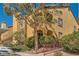 Charming condo featuring an stucco exterior, a walkway entrance, and mature shade trees creating a welcoming curb appeal at 7950 W Flamingo Rd # 1081, Las Vegas, NV 89147