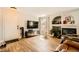 Cozy living room featuring a fireplace, television, wood-look flooring, and a comfortable leather chair at 7950 W Flamingo Rd # 1081, Las Vegas, NV 89147