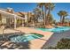 Inviting community pool and hot tub featuring ample lounge seating and lush landscaping at 7950 W Flamingo Rd # 1081, Las Vegas, NV 89147