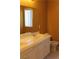 Bathroom featuring a white vanity with double sinks, ample counter space, and a window for natural light at 8003 Retriever Ave, Las Vegas, NV 89147