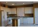 Bright kitchen featuring white cabinets, an island, granite countertops, and stainless steel appliances at 8003 Retriever Ave, Las Vegas, NV 89147