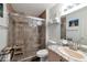 Bathroom featuring shower with glass door, granite countertops, and modern fixtures at 8440 Wandering Sun Ave, Las Vegas, NV 89129