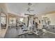 Well-equipped community gym with exercise machines, weights, ceiling fans, and a view of the pool at 8440 Wandering Sun Ave, Las Vegas, NV 89129