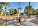 Community park features a picnic table, mature trees, desert landscaping, and a winding sidewalk at 8440 Wandering Sun Ave, Las Vegas, NV 89129