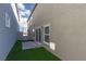 Low maintenance backyard featuring artificial grass, pavers and privacy gate to the alley way at 9099 Nostrand Ave, Las Vegas, NV 89148