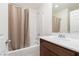 Bathroom with a shower-tub combo, white tiled walls, and a modern vanity at 9099 Nostrand Ave, Las Vegas, NV 89148