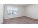 Empty bedroom featuring neutral carpet, white walls, and two windows at 9099 Nostrand Ave, Las Vegas, NV 89148