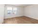 Bedroom with wood-look flooring and window with neighborhood view at 9099 Nostrand Ave, Las Vegas, NV 89148
