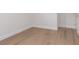 Bedroom showcasing wood-look floors, white trim, and a door leading to another room at 9099 Nostrand Ave, Las Vegas, NV 89148