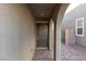 Covered entryway with arched support leading to front door and gated side yard at 9099 Nostrand Ave, Las Vegas, NV 89148