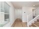 Inviting entryway with wood-look flooring, natural light from a window, and access to the staircase at 9099 Nostrand Ave, Las Vegas, NV 89148