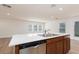 Modern kitchen island with sleek countertops and stainless steel appliances and fixtures at 9099 Nostrand Ave, Las Vegas, NV 89148