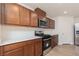 Close-up of kitchen with stainless steel appliances, sleek countertops, and wood cabinetry at 9099 Nostrand Ave, Las Vegas, NV 89148