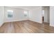 Living room showcasing wood-look floors and two windows providing natural light at 9099 Nostrand Ave, Las Vegas, NV 89148