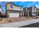 Home featuring an attached two-car garage and low maintenance desert landscaping at 920 Lotus Falls St, Henderson, NV 89052