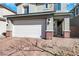 Close up of the home and attached two-car garage with brick accents at 920 Lotus Falls St, Henderson, NV 89052