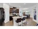 Bright kitchen with an island, stainless steel appliances, dark cabinets, and an adjacent dining area at 920 Lotus Falls St, Henderson, NV 89052