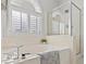 Elegant bathroom with a soaking tub, separate glass shower, and white shuttered window at 1065 Otto Ridge Ct, Henderson, NV 89052