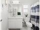 Bright bathroom featuring a white vanity with marble countertop and a decorative striped shower curtain at 1065 Otto Ridge Ct, Henderson, NV 89052