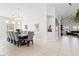 Bright dining room with a long table, comfortable seating, and views of the backyard at 1065 Otto Ridge Ct, Henderson, NV 89052