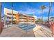 Inviting community pool with clear blue water, poolside seating, palm trees, and nearby apartments at 1381 E University Ave # 204, Las Vegas, NV 89119