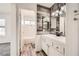 A renovated bathroom with wood accent wall, modern vanity, and a shower-tub combination with white tile surround at 1411 Linnbaker Ln # 202, Las Vegas, NV 89110