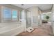 Bathroom featuring a soaking tub, glass shower, and natural light at 194 Carlsbad Caverns St, Henderson, NV 89012