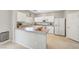 Bright kitchen with white cabinetry, modern appliances, and a functional breakfast bar for casual dining at 194 Carlsbad Caverns St, Henderson, NV 89012