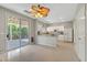 Bright kitchen featuring white cabinetry, tile floors and sliding glass doors to the backyard patio at 194 Carlsbad Caverns St, Henderson, NV 89012