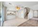 Open concept living area and kitchen with tile floors and carpet, with a staircase to the second floor at 194 Carlsbad Caverns St, Henderson, NV 89012