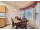 Cozy dining area with a wooden table and chairs by a bright window at 1943 Chickasaw Dr, Henderson, NV 89002