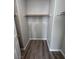 Walk-in closet offering ample storage space with a wooden rod and shelf at 2504 Trustworthy Ave, North Las Vegas, NV 89031